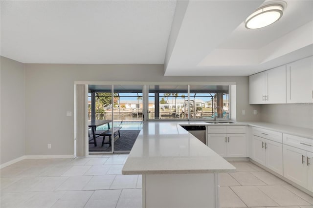 kitchen featuring sink, white cabinets, a center island, dishwasher, and light stone counters