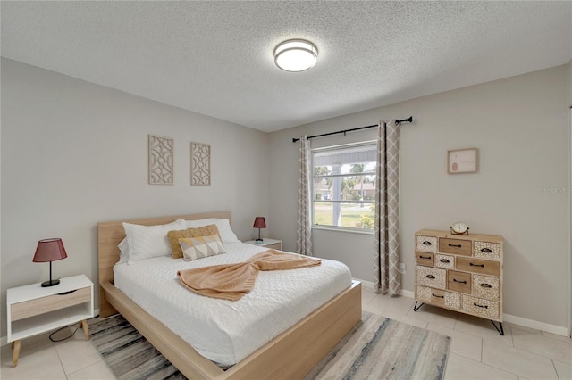 tiled bedroom with a textured ceiling