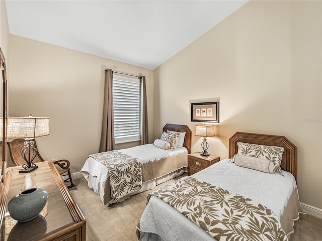 bedroom with lofted ceiling and light carpet