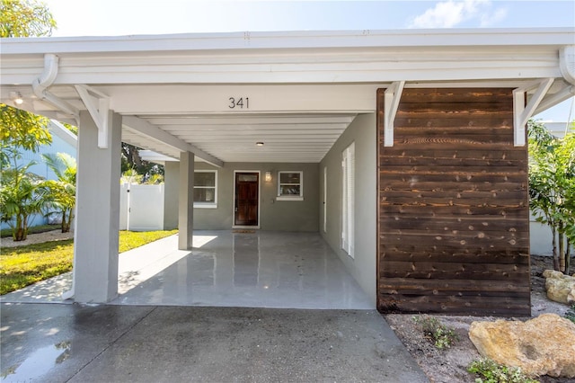 view of parking / parking lot featuring a carport