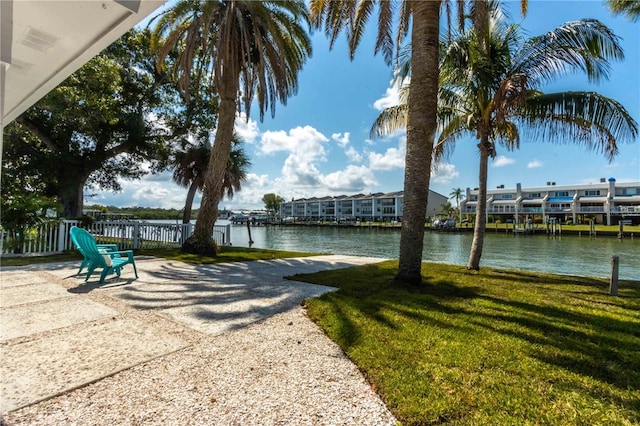 dock area featuring a water view and a lawn