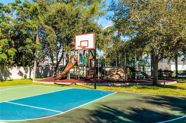 view of basketball court featuring a playground