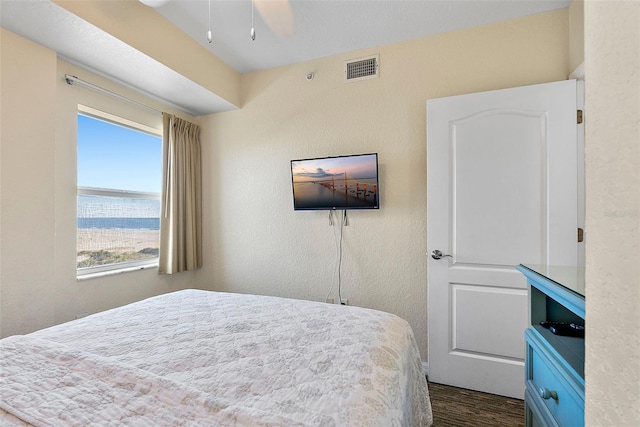 bedroom with ceiling fan and dark hardwood / wood-style floors