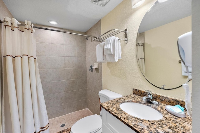 bathroom featuring a shower with curtain, vanity, and toilet