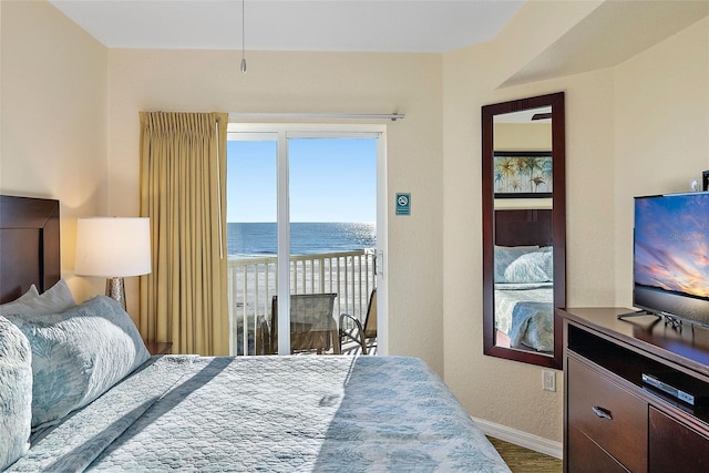 bedroom featuring access to outside and hardwood / wood-style flooring