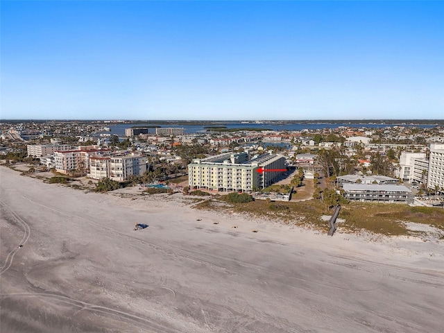 drone / aerial view featuring a water view and a beach view