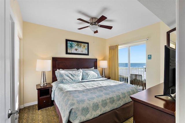 bedroom featuring ceiling fan, dark wood-type flooring, and access to outside