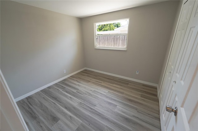 unfurnished bedroom with a closet and light wood-type flooring