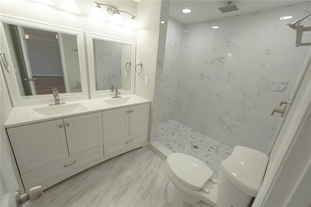 bathroom featuring tiled shower, vanity, and toilet