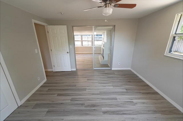 unfurnished room featuring ceiling fan and light wood-type flooring