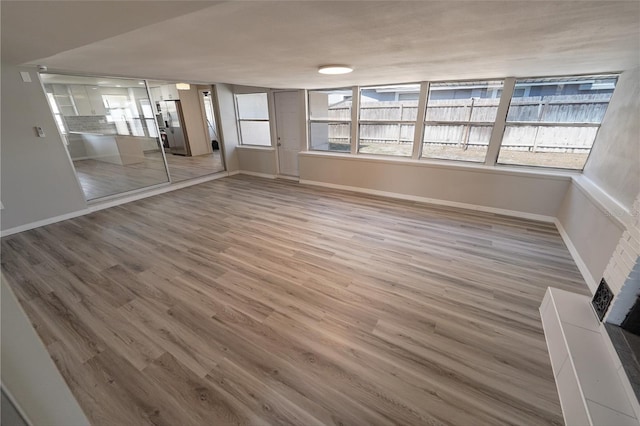 interior space with a fireplace and hardwood / wood-style floors