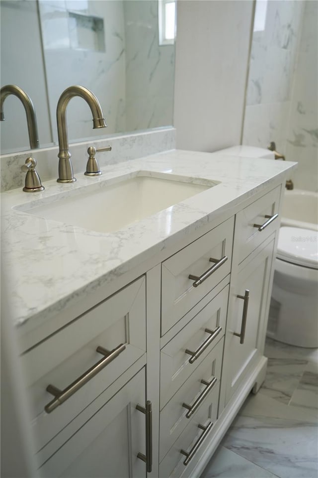 bathroom with vanity and toilet