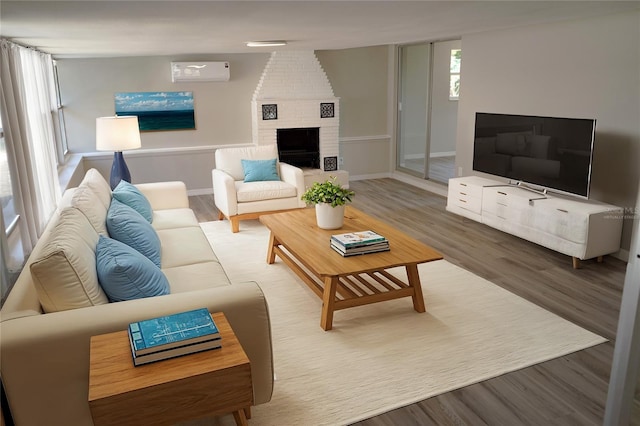 living room featuring wood finished floors, baseboards, and a brick fireplace