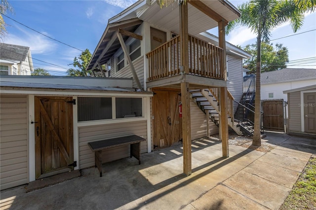 rear view of property with a storage shed