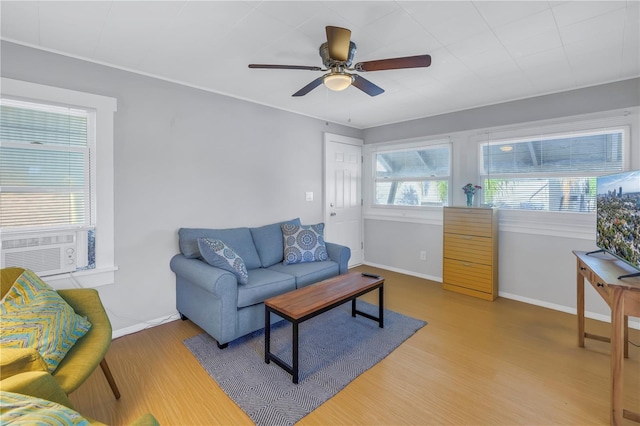 living room with ceiling fan, cooling unit, and wood-type flooring