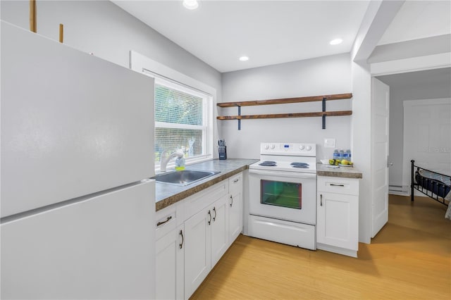 kitchen featuring white cabinets, white appliances, sink, and light hardwood / wood-style flooring