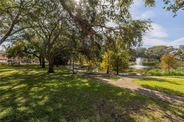 surrounding community featuring a lawn and a water view