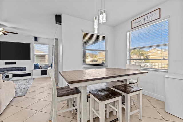 tiled dining room featuring ceiling fan