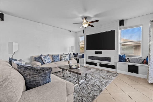 tiled living room with plenty of natural light and ceiling fan