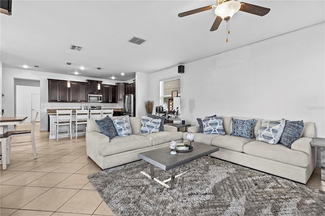 living room featuring ceiling fan and light tile patterned floors