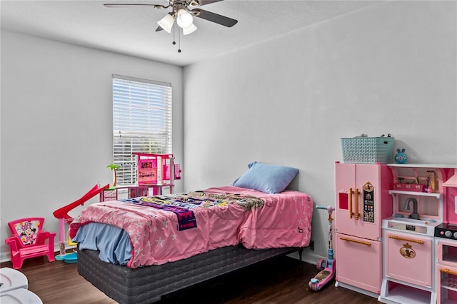 bedroom featuring dark hardwood / wood-style floors, ceiling fan, and white fridge