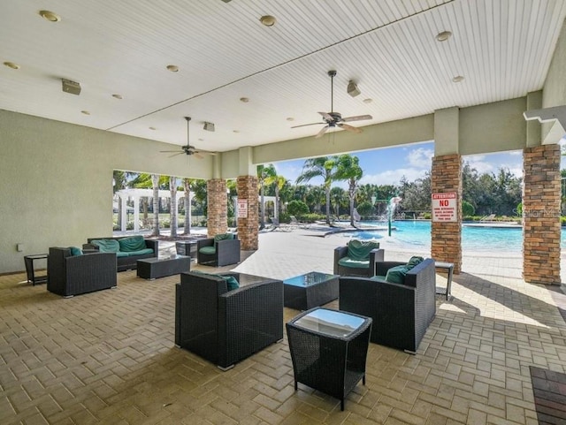 view of patio / terrace featuring outdoor lounge area, ceiling fan, and a community pool