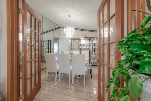 unfurnished dining area with french doors, an inviting chandelier, a textured ceiling, vaulted ceiling, and light tile patterned flooring