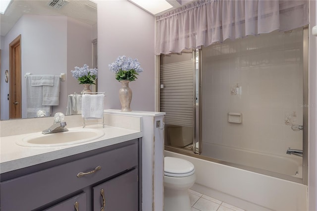 full bathroom featuring toilet, tile patterned flooring, vanity, and combined bath / shower with glass door