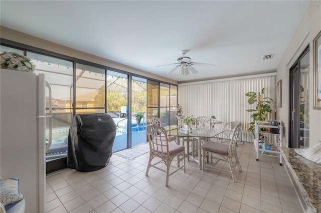 sunroom featuring ceiling fan