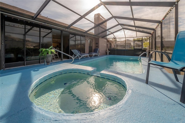 view of swimming pool featuring a patio area, a lanai, and an in ground hot tub