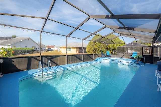 view of swimming pool featuring glass enclosure