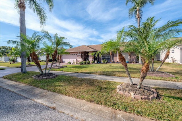 view of front of house with a front yard and a garage