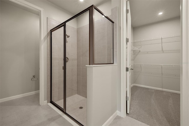 bathroom with walk in shower and tile patterned floors