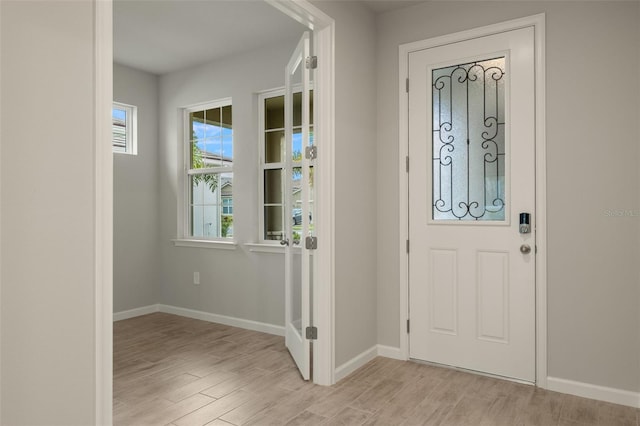 entrance foyer featuring light wood-type flooring and a wealth of natural light