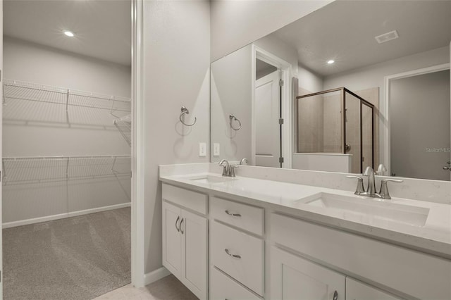 bathroom featuring vanity and a shower with door