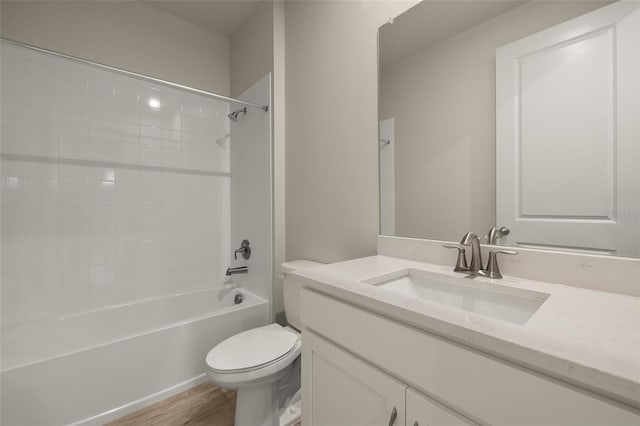 full bathroom with vanity, bathtub / shower combination, hardwood / wood-style floors, and toilet