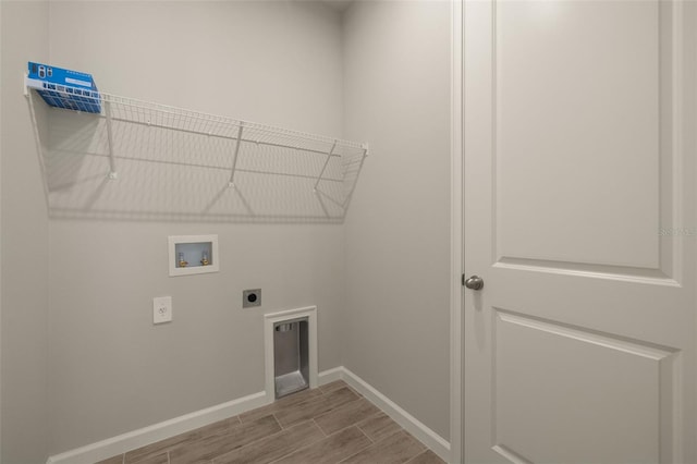 clothes washing area featuring hookup for a washing machine and hookup for an electric dryer