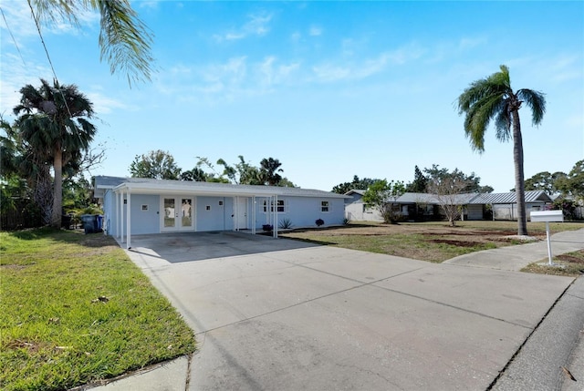 ranch-style home featuring french doors and a front lawn