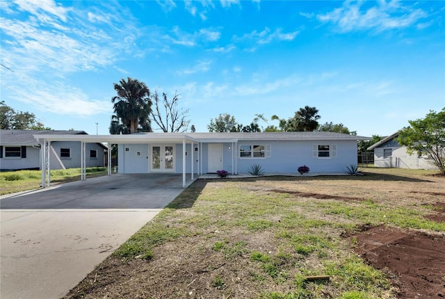 ranch-style house with a front yard and a carport