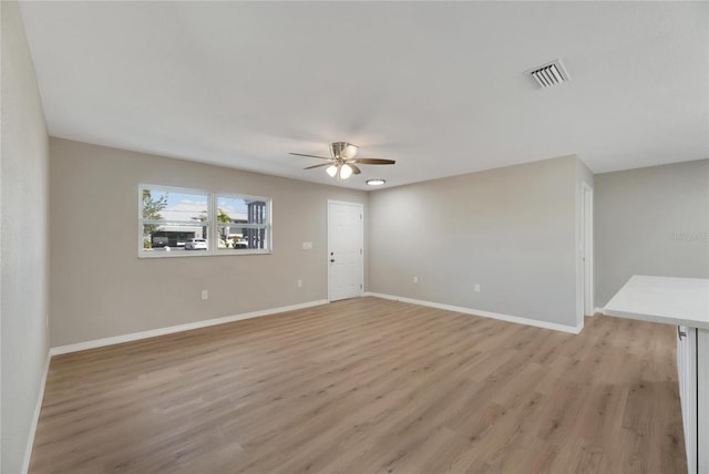 unfurnished room featuring ceiling fan and light wood-type flooring