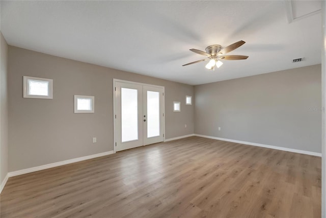 unfurnished room with ceiling fan, french doors, and light hardwood / wood-style floors