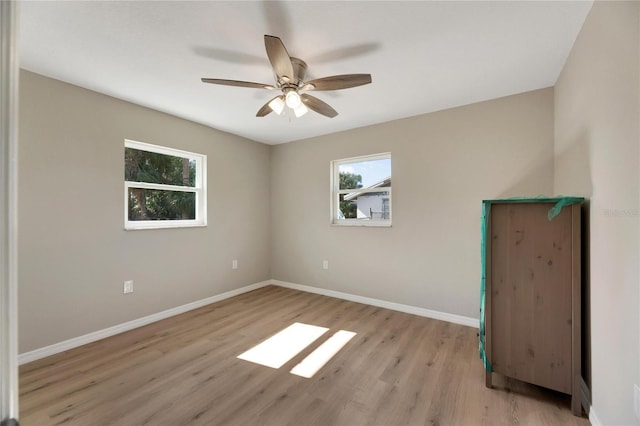 spare room featuring ceiling fan and light hardwood / wood-style flooring