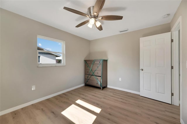 unfurnished bedroom with ceiling fan and light hardwood / wood-style floors