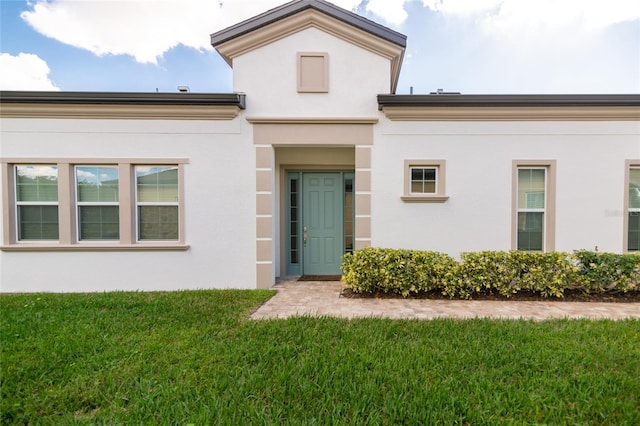 property entrance with a yard