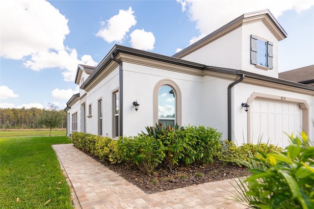 view of home's exterior featuring a yard and a garage