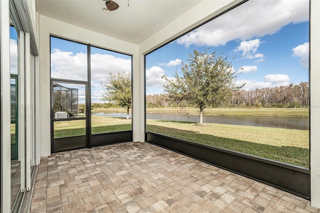 unfurnished sunroom with a water view