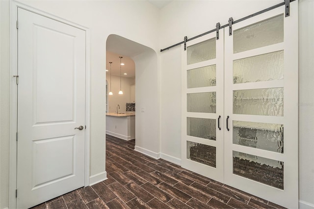 hall with dark wood-type flooring and sink