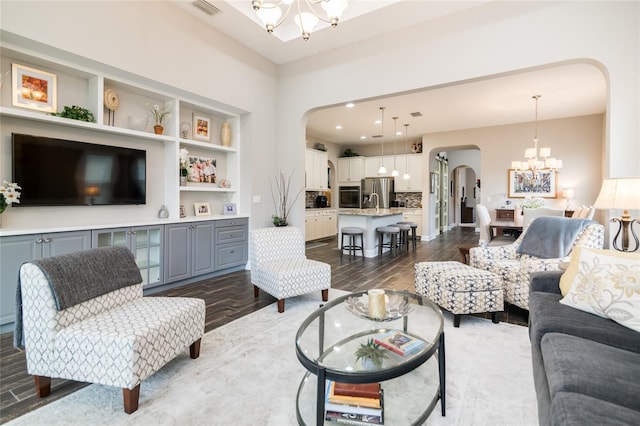 living room featuring dark hardwood / wood-style floors and an inviting chandelier