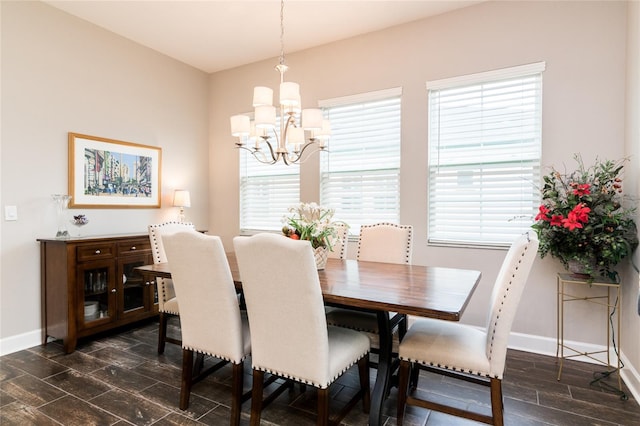 dining area featuring a wealth of natural light, dark hardwood / wood-style flooring, and an inviting chandelier