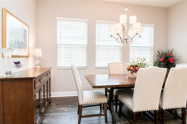 dining space featuring a chandelier, dark hardwood / wood-style flooring, and a wealth of natural light